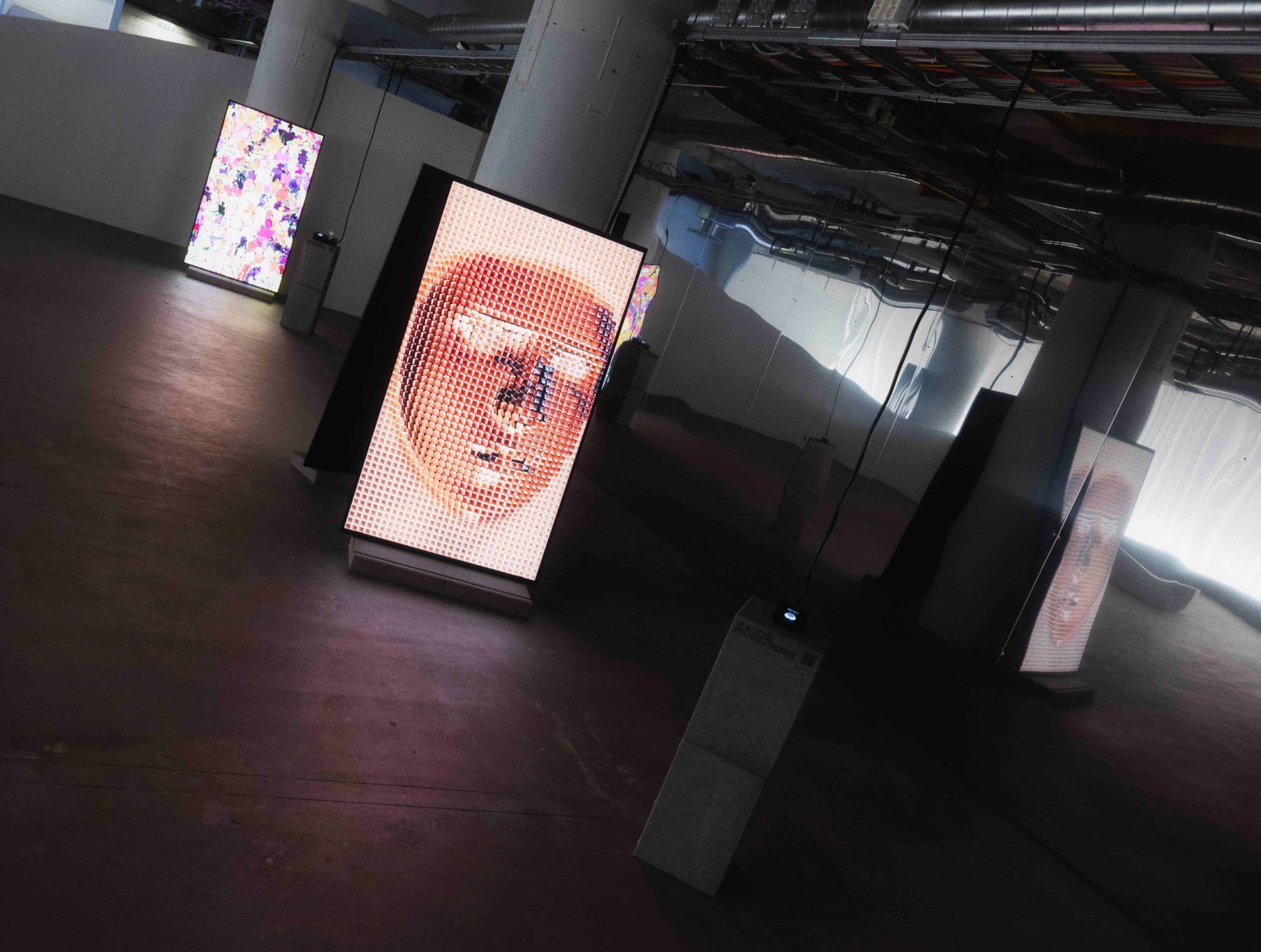 exhibition view with lit screens