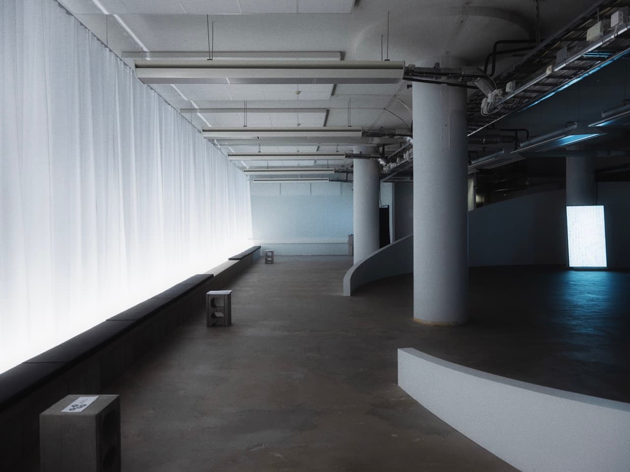 gallery space with lit curtain