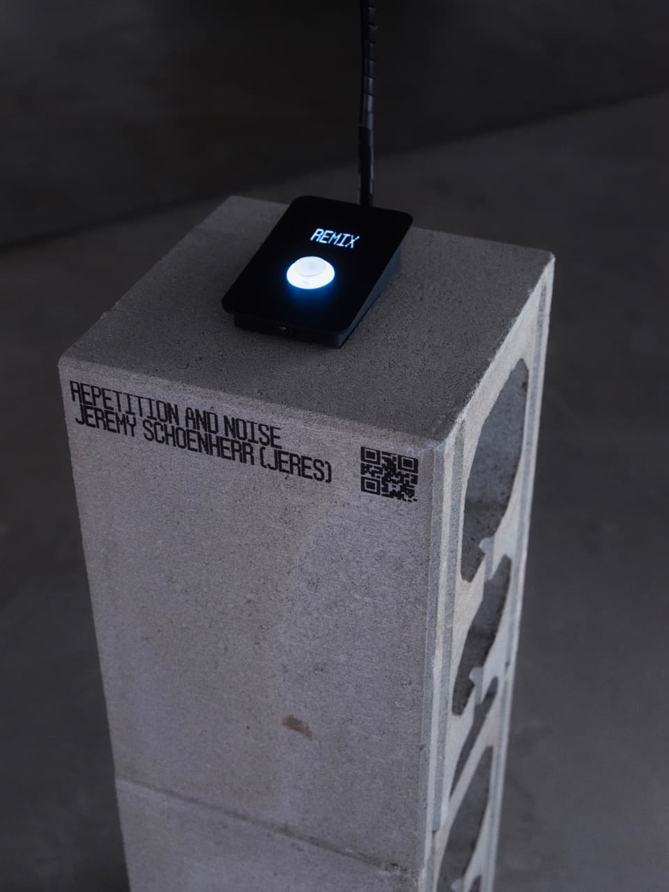 remix button on a concrete plinth